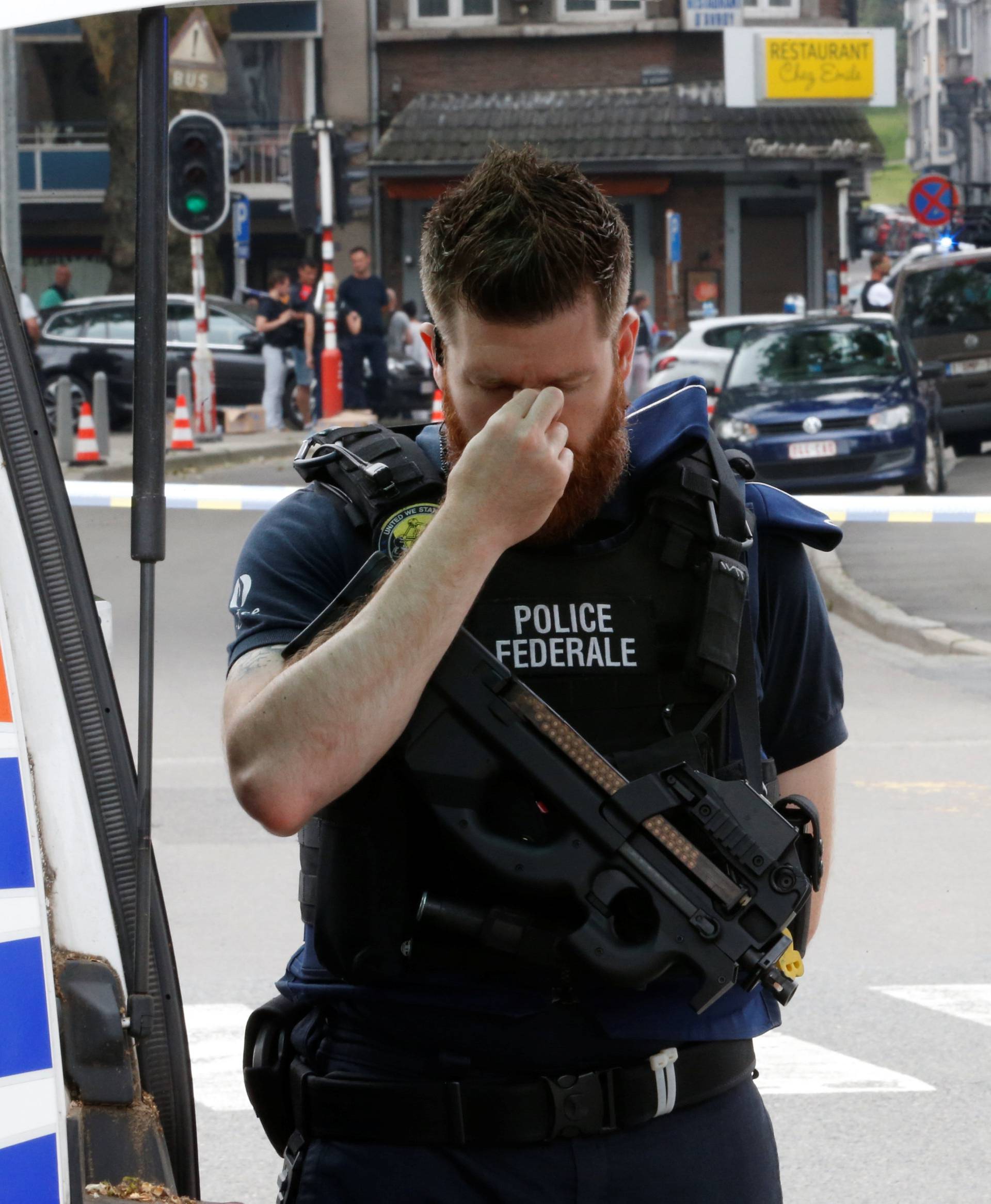 A police officer is seen on the scene of a shooting in Liege