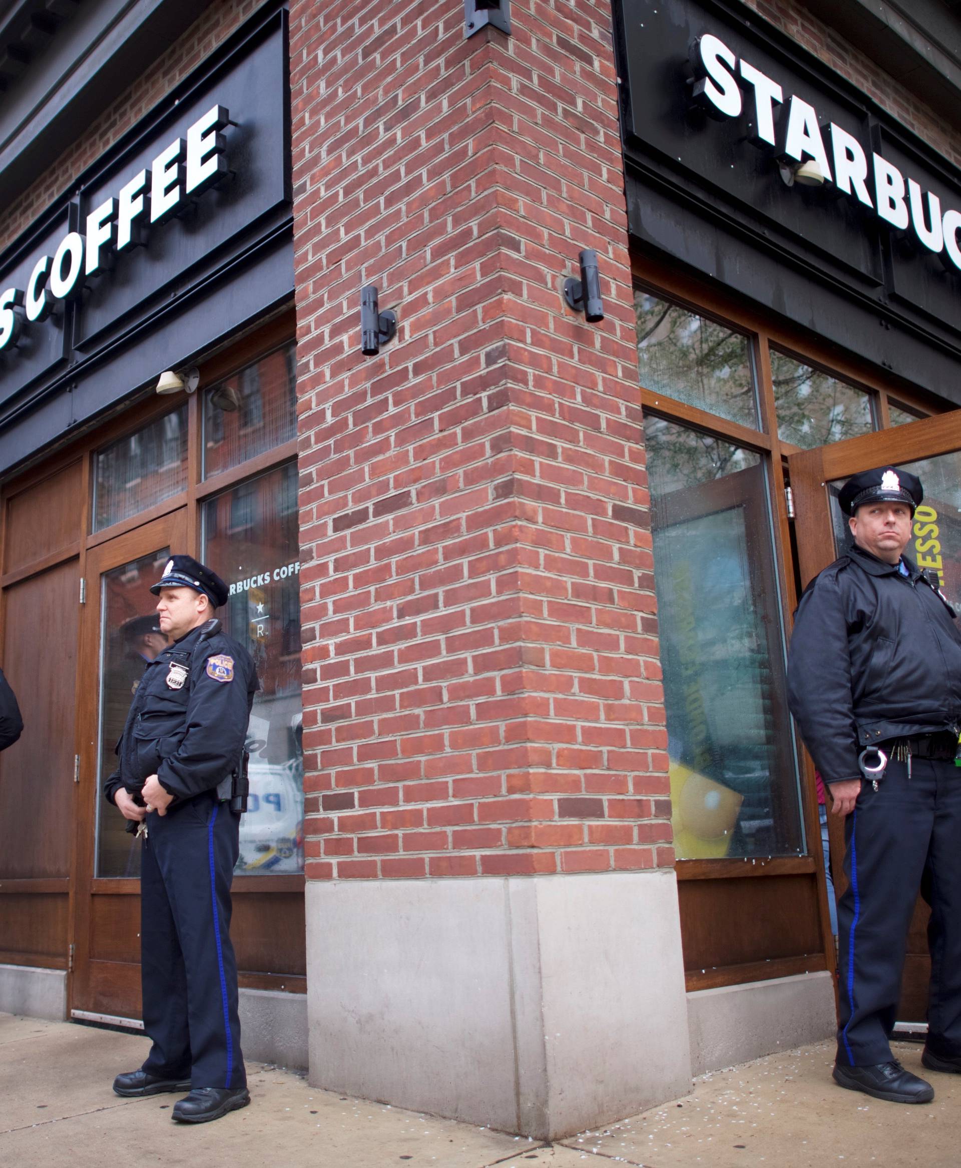 Police officers monitor activity outside as protestors demonstrate inside a Center City Starbucks, where two black men were arrested, in Philadelphia