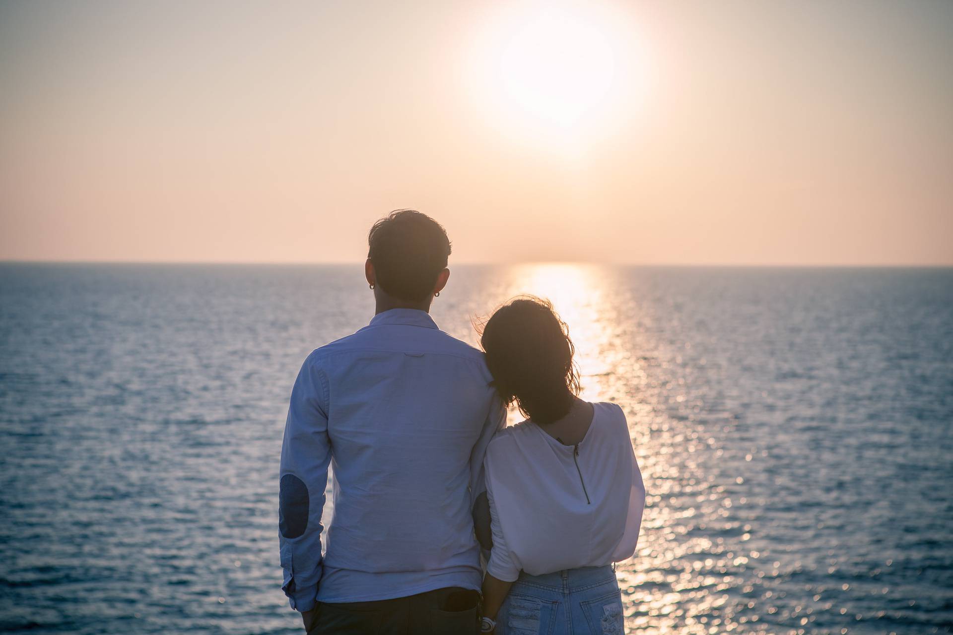 hipster photography style of younger love couples vacation relaxing with sun set sky at destination sea side happiness emotion