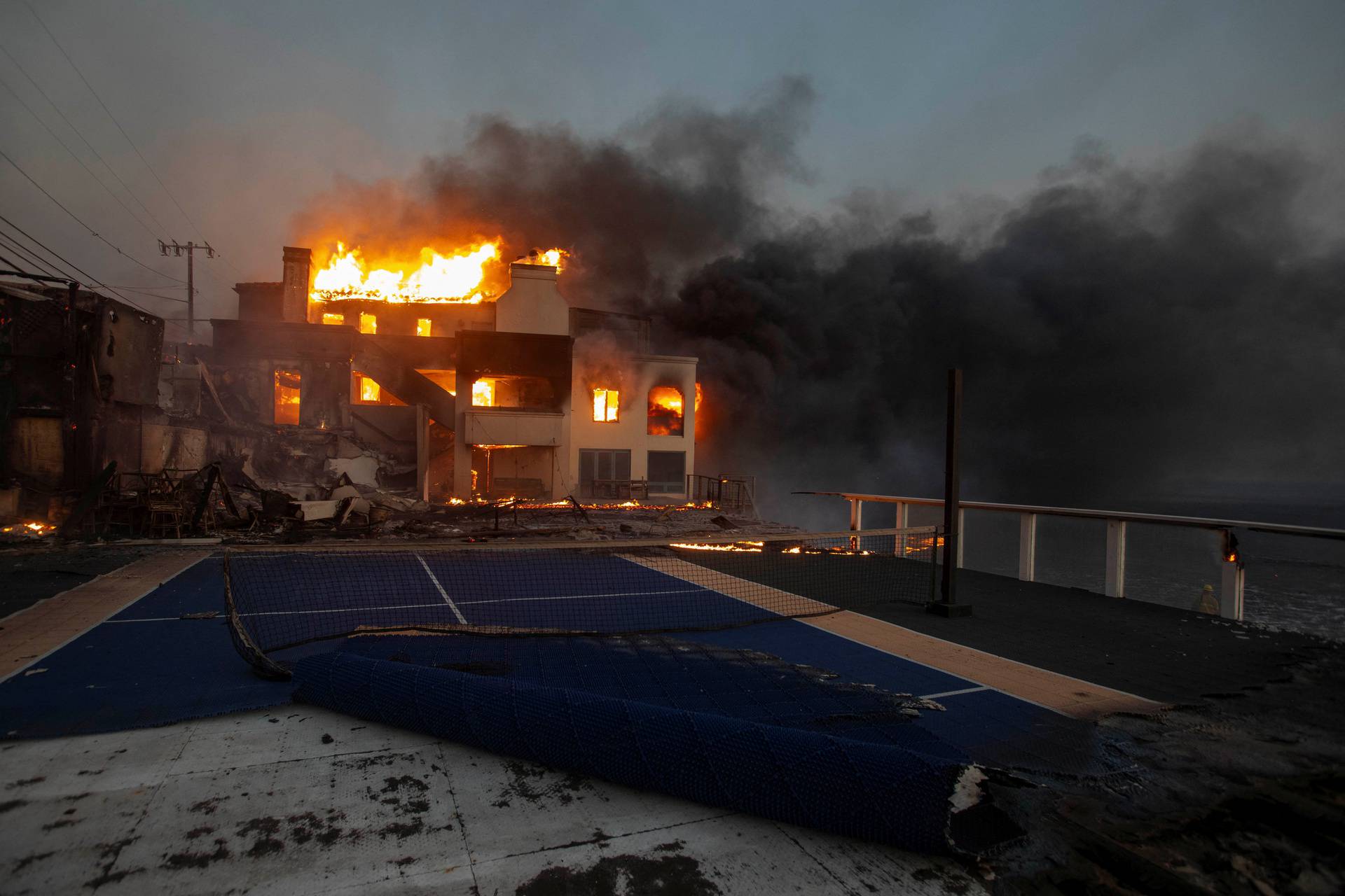 Palisades fire burns during a windstorm on the west side of Los Angeles