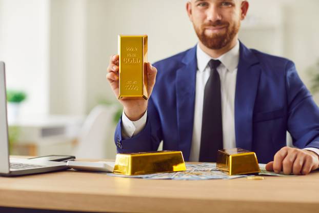 Happy,Young,Confident,Businessman,In,Suit,Sitting,At,Desk,With