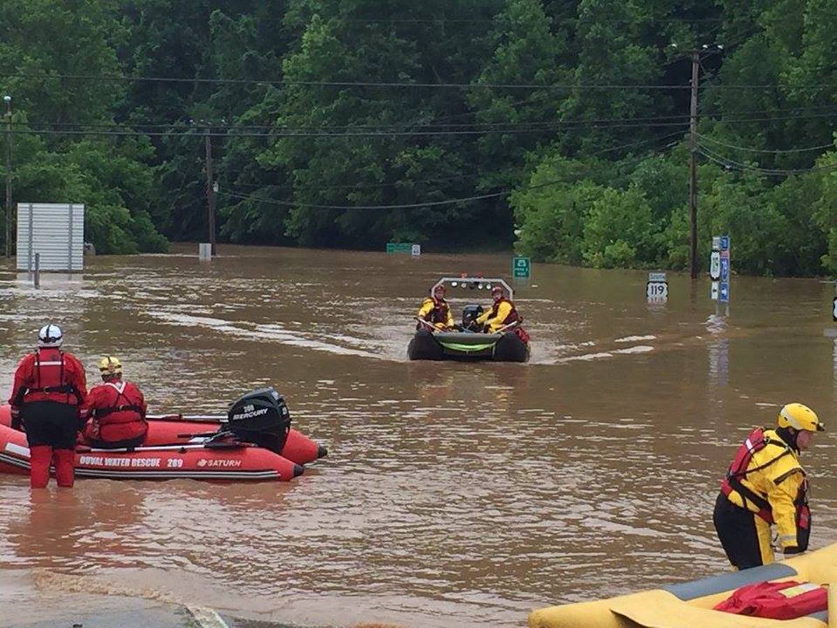 Emergency crews take out boats on a flooded I-79 at the Clendenin Exit in Kanawha County