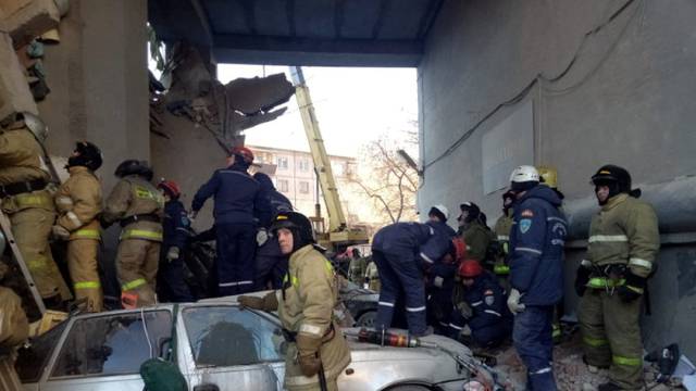 Emergency personnel work at the site of collapsed apartment building after a suspected gas blast in Magnitogorsk