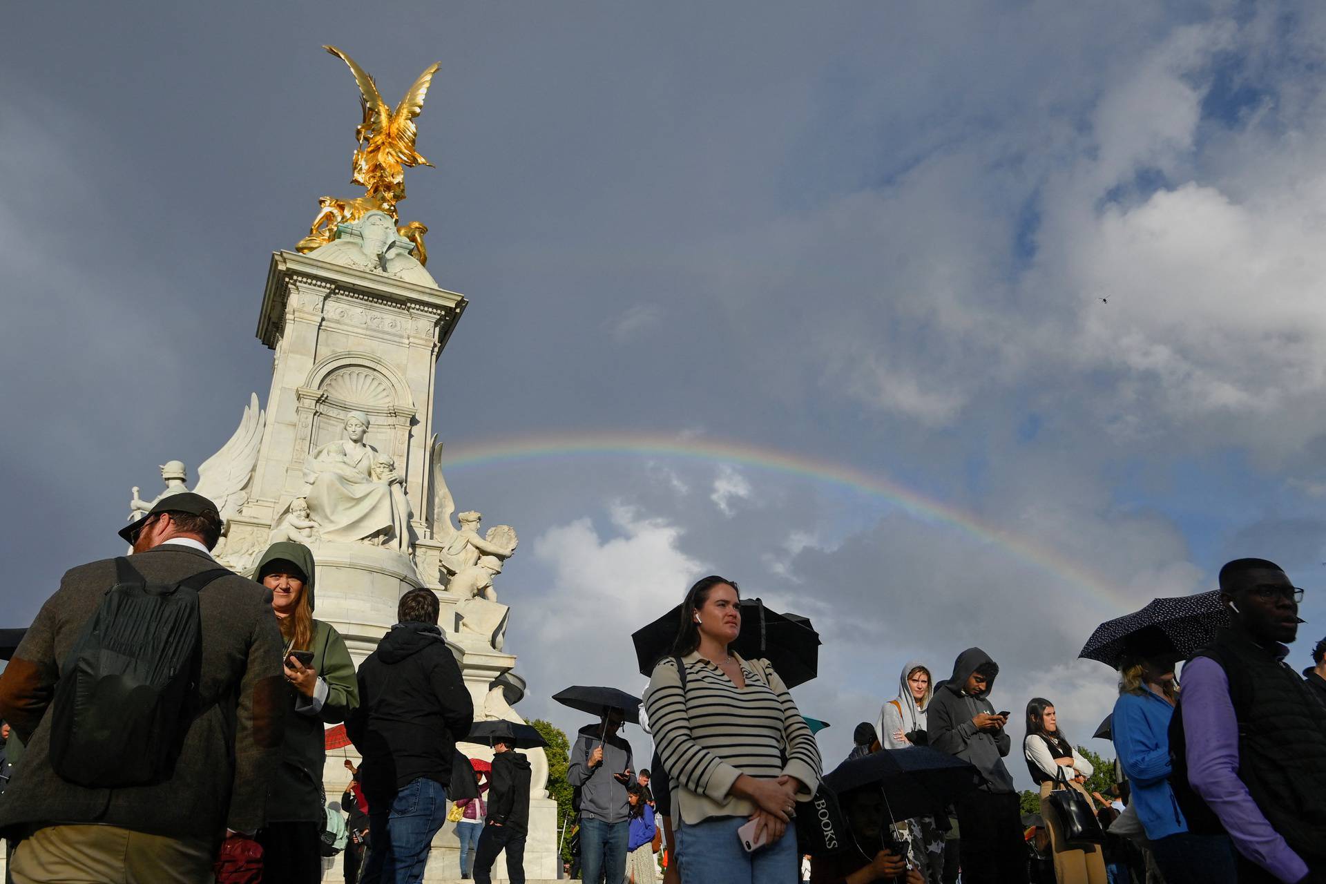 People gather outside Buckingham Palace in London