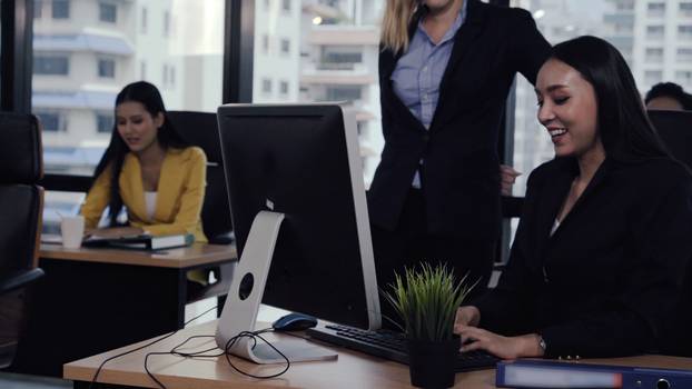 Young leader gives advice to young woman worker.