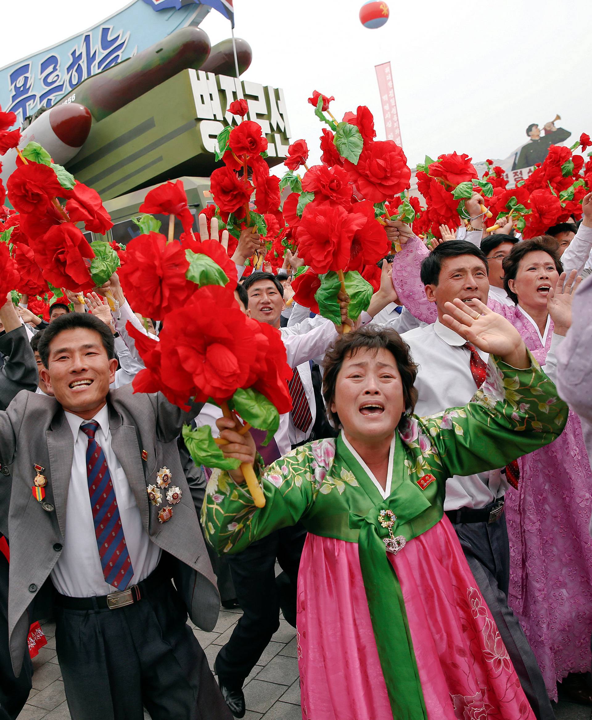 People react as they see North Korean leader Kim Jong Un during a mass rally and parade in Pyongyang
