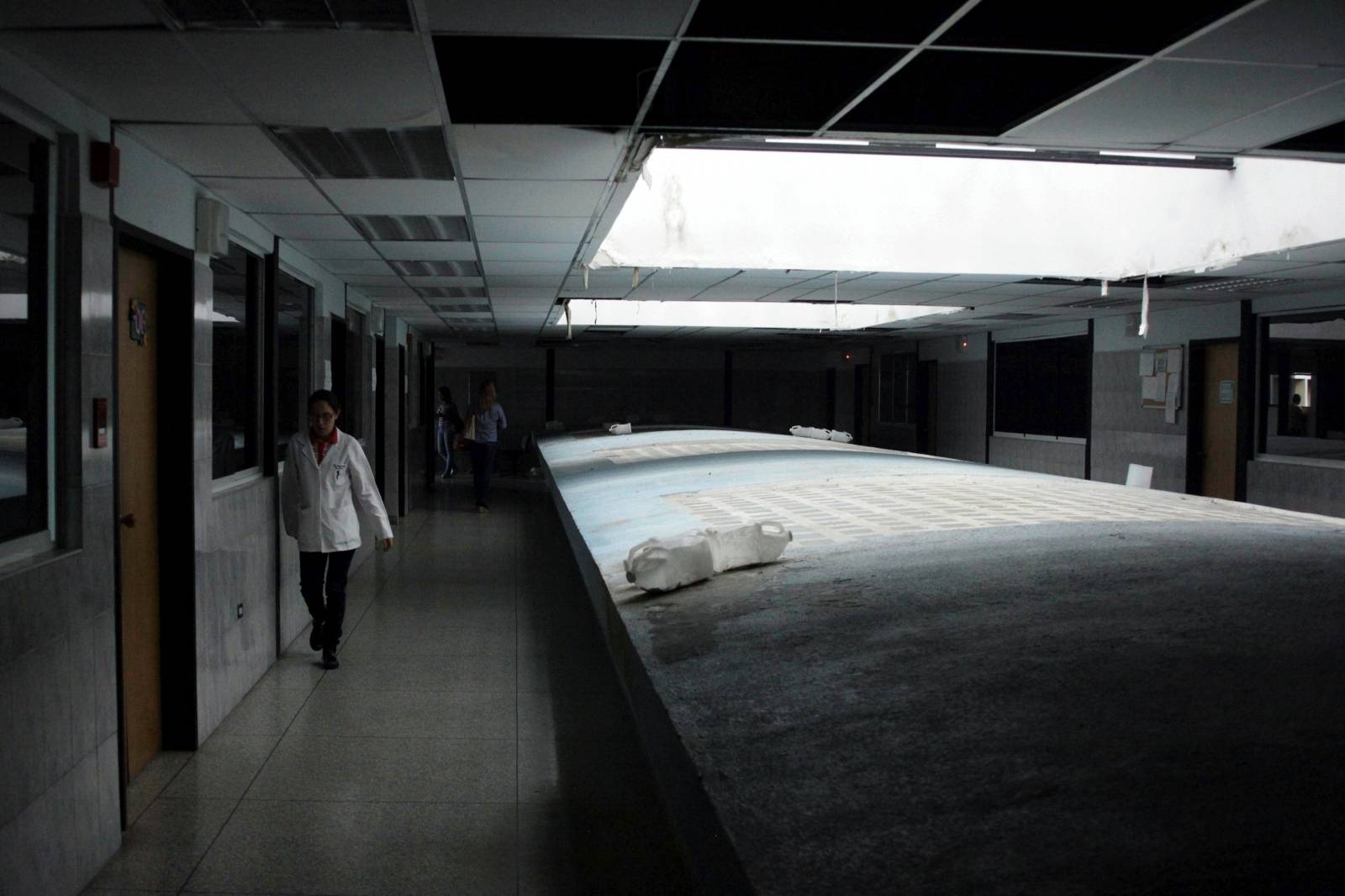 People walk at a hospital, whose power is supplied by generators, during a blackout in San Cristobal