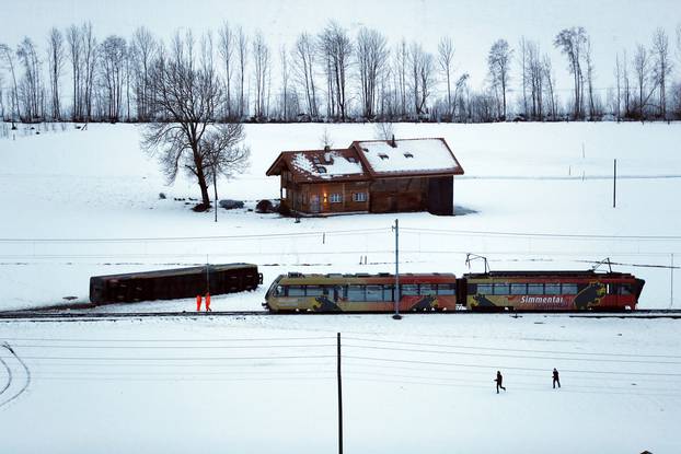 A carriage of the MOB train is pictured lying on its side after if was pushed out of the tracks by gusts of wind during storm Eleanor near Lenk