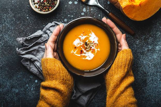 Female,Hands,In,Yellow,Knitted,Sweater,Holding,A,Bowl,With