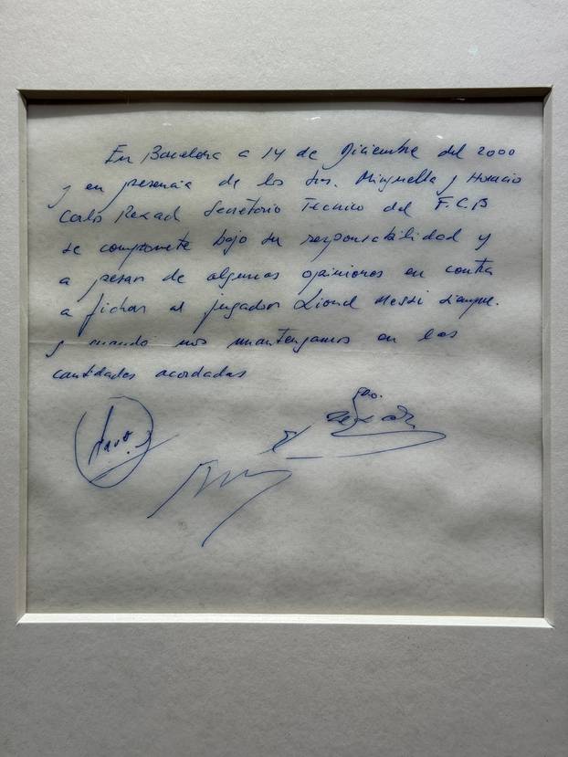 Signed and framed napkin on which soccer club Barcelona promised to sign a 13-year-old Lionel Messi is displayed at the Bonhams auction house in London