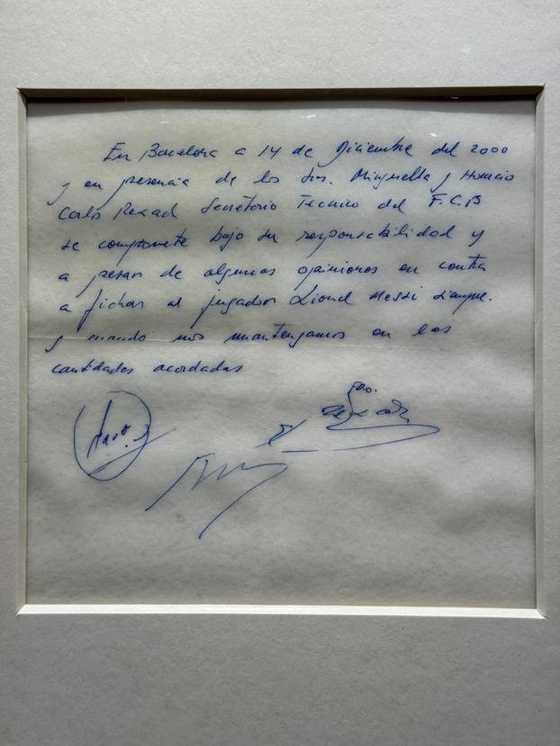 Signed and framed napkin on which soccer club Barcelona promised to sign a 13-year-old Lionel Messi is displayed at the Bonhams auction house in London