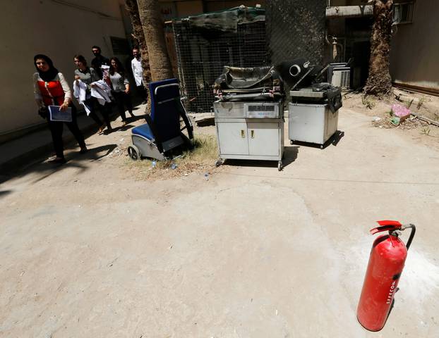 Burnt incubators stand outside a maternity ward after a fire broke out at Yarmouk hospital in Baghdad