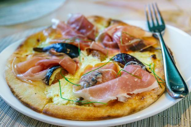 Delicious pizza close up on wooden board and concepts. Italian national food.