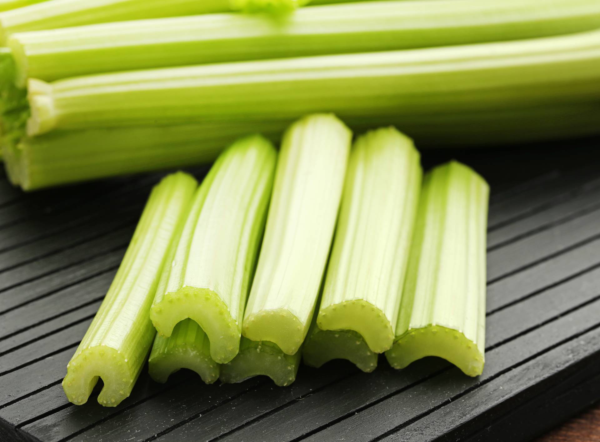 Celery on black cutting board