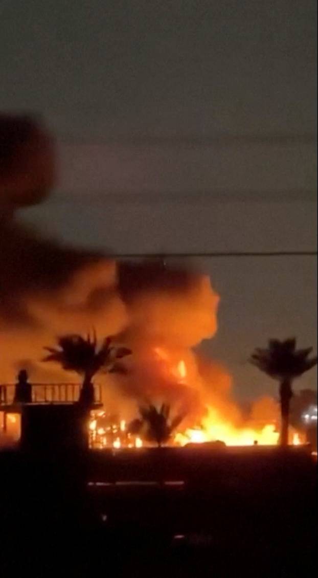 Fire and smoke plumes rise from a U.S. diplomatic facility near Baghdad airport