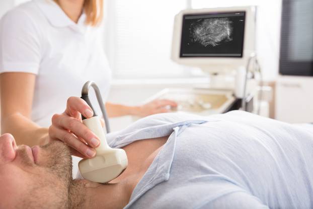 Male,Patient,Undergoing,Ultrasound,Of,Thyroid,Gland,In,Examination,Room