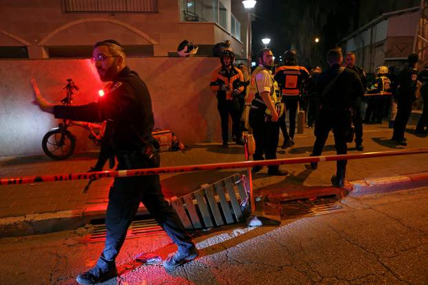 Israeli security and medical personnel secure the scene of an attack in which people were killed by a gunman on a main street in Bnei Brak, near Tel Aviv