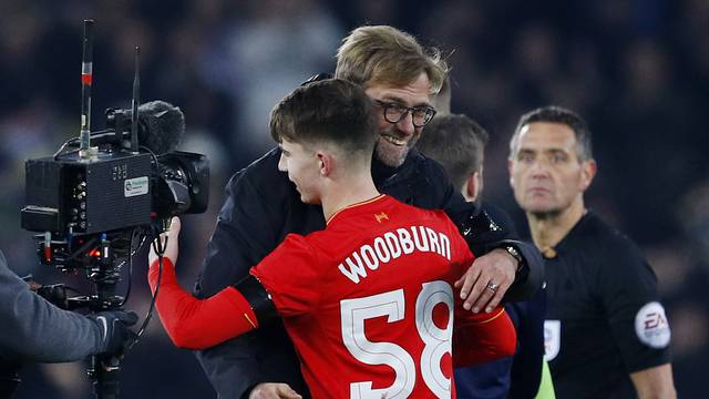 Liverpool's Ben Woodburn and manager Juergen Klopp celebrate after the game