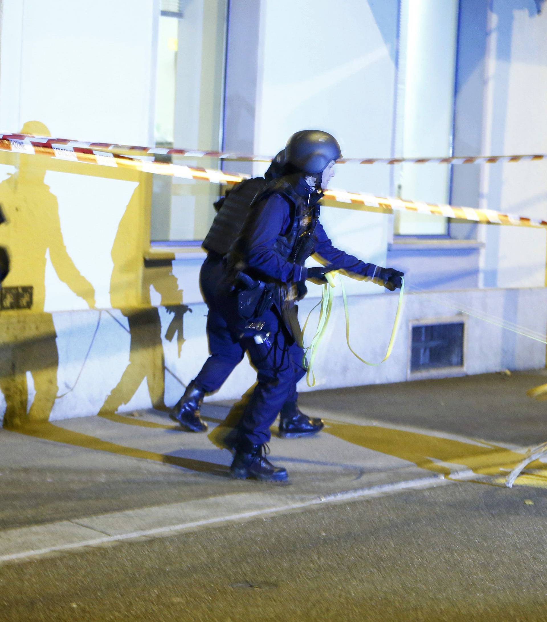 Police stand outside an Islamic center in central Zurich