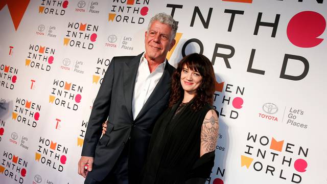 FILE PHOTO: Anthony Bourdain poses with Italian actor and director Asia Argento for the Women In The World Summit in New York
