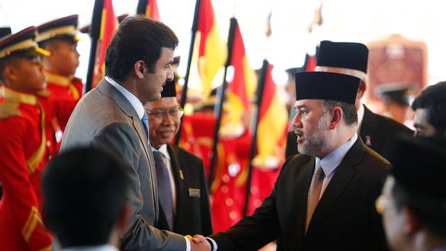 FILE PHOTO: Qatar's Emir Sheikh Tamim bin Hamad al-Thani shakes hand with Malaysia's King Muhammad V after a state welcome ceremony at the Parliament House in Kuala Lumpur