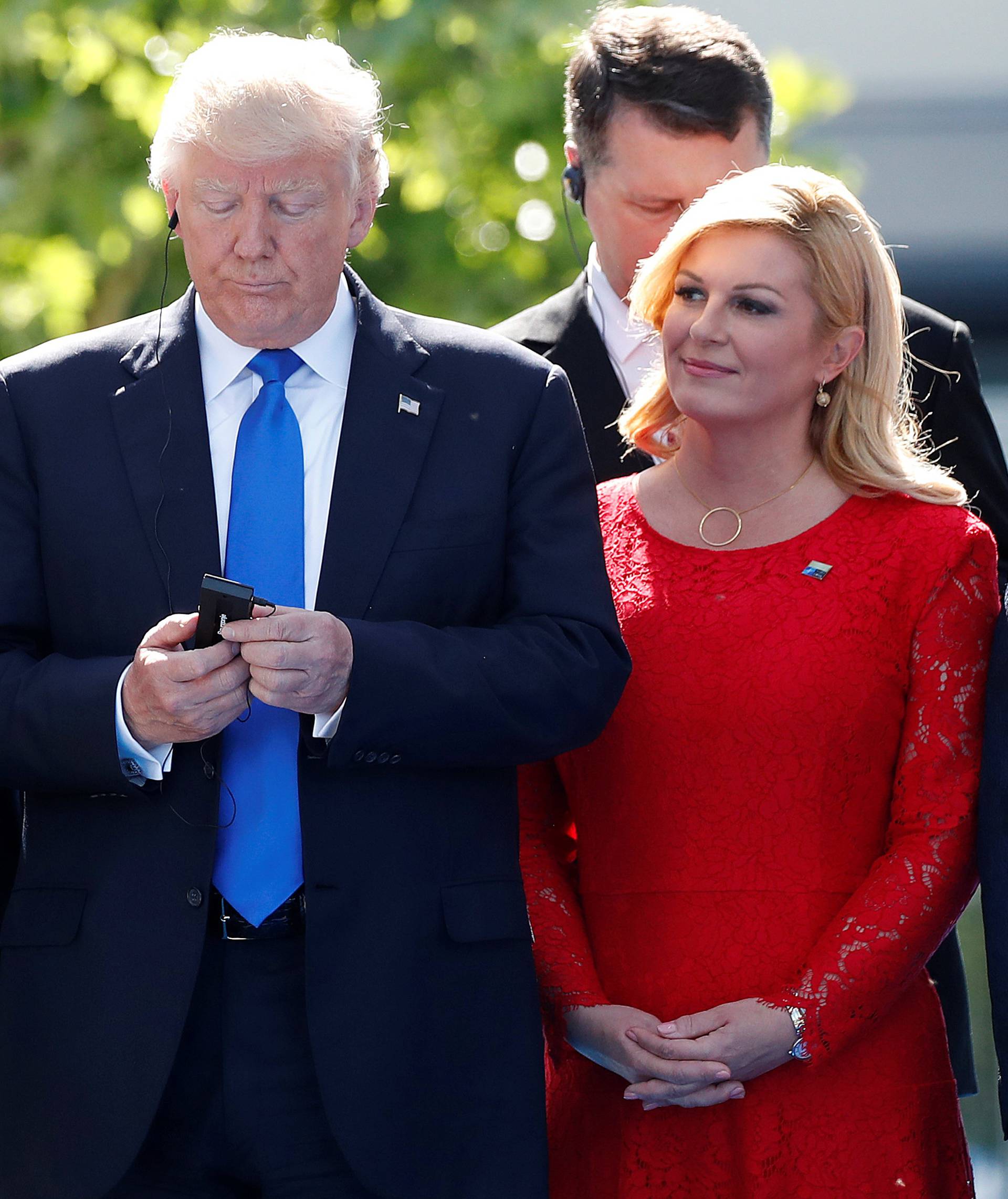 U.S. President Donald Trump reacts at the start of the NATO summit at their new headquarters in Brussels