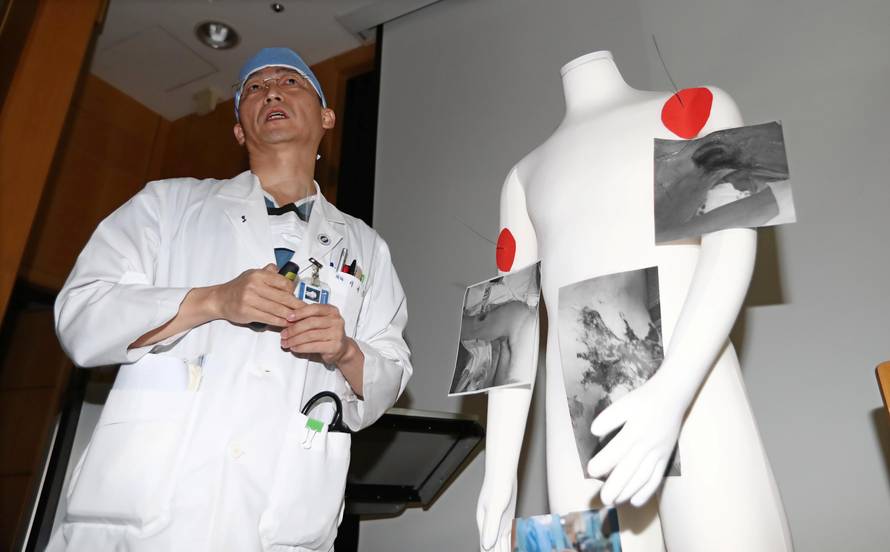 A surgeon Lee Cook-jong gives a briefing during a news conference at a hospital in Suwon