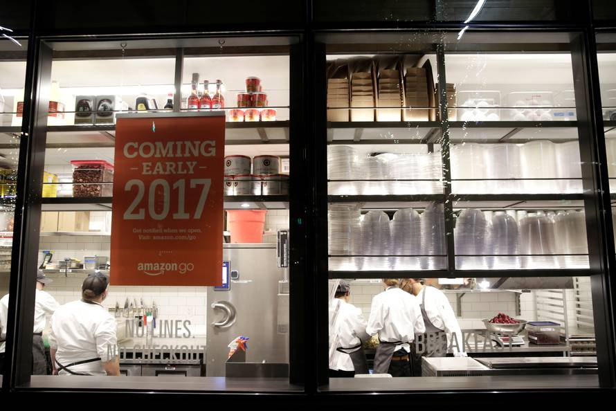 Kitchen staff are pictured inside the Amazon Go brick-and-mortar grocery store without lines or checkout counters, in Seattle Washington