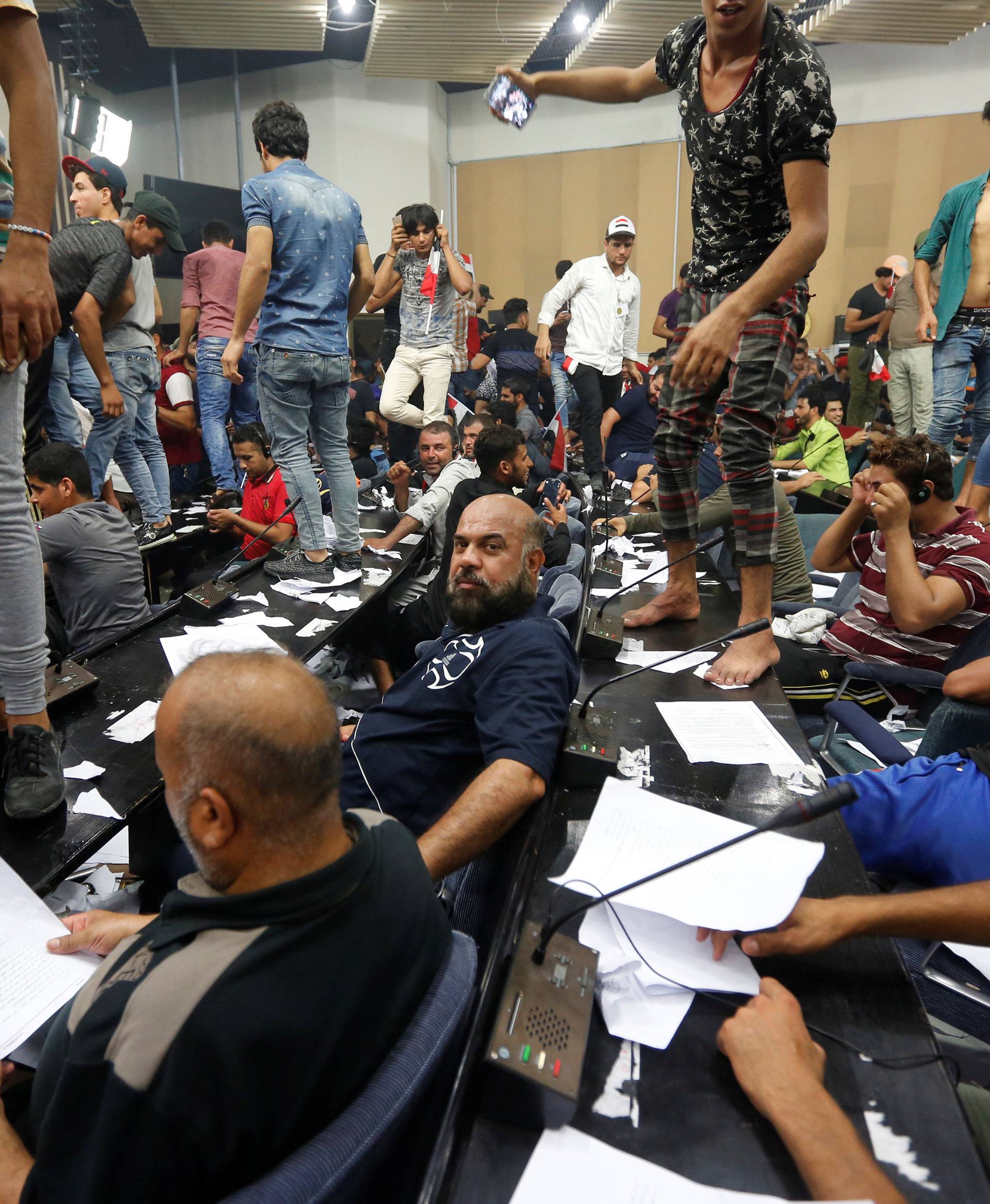 Followers of Iraq's Shi'ite cleric Moqtada al-Sadr are seen in the parliament building as they storm Baghdad's Green Zone after lawmakers failed to convene for a vote on overhauling the government, in Iraq