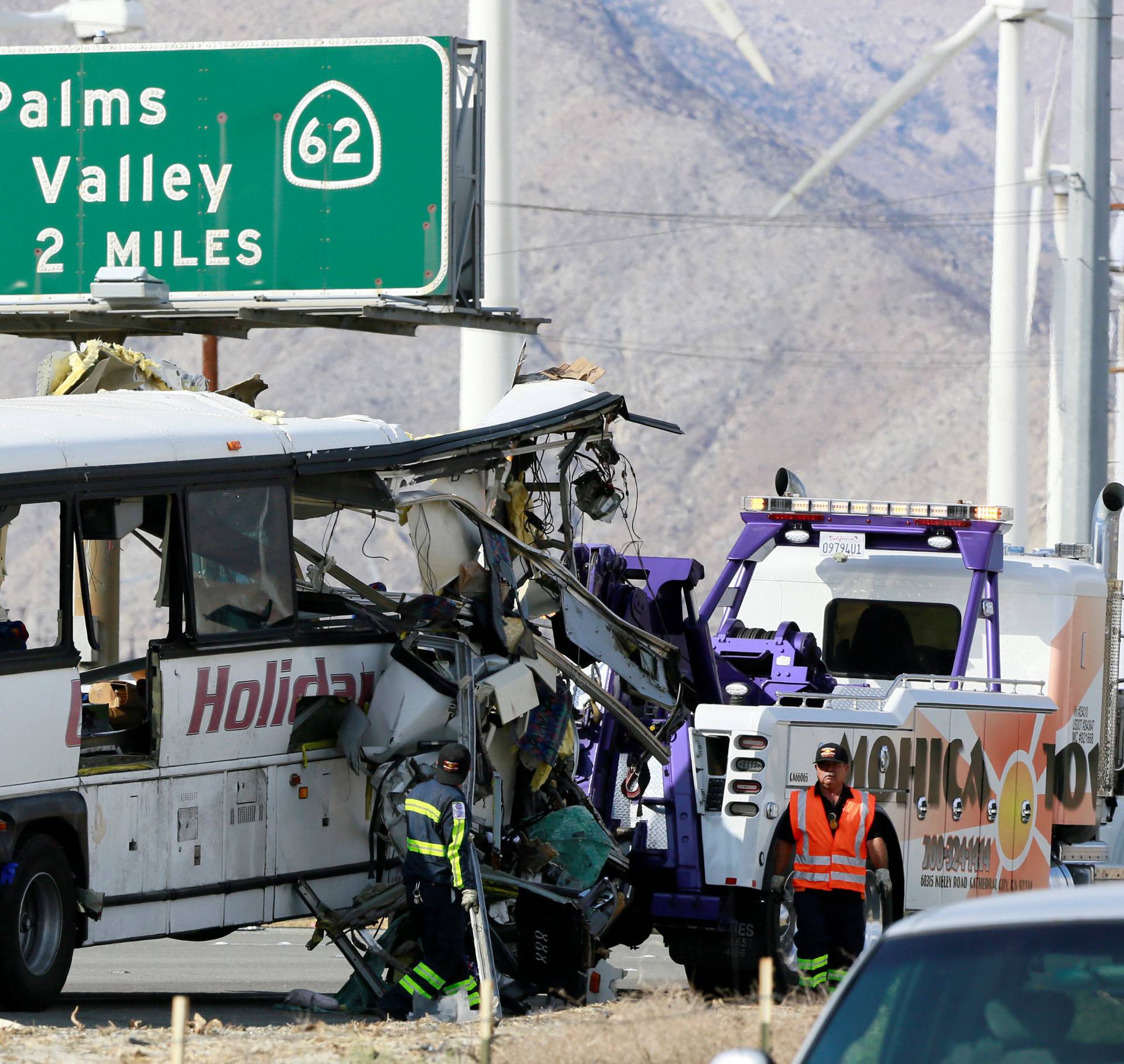 A mangled bus from the Holiday Bus Lines is seen after being towed from the scene of a mass casualty crash on the westbound Interstate 10 freeway near Palm Springs, California