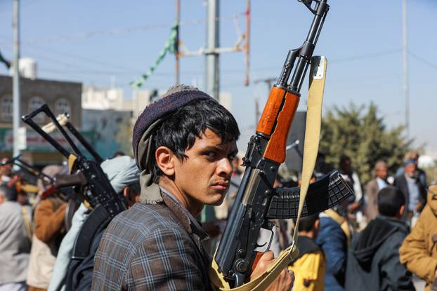 A newly recruited Houthi fighter looks on during a ceremony at the end of his training in Sanaa