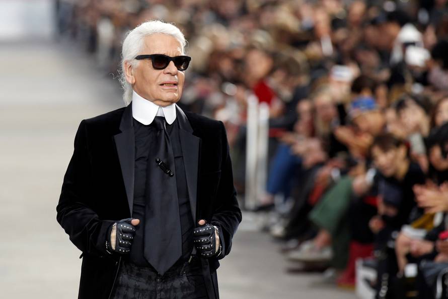 FILE PHOTO -  German designer Karl Lagerfeld appears at the end of his Spring/Summer 2014 women's ready-to-wear fashion show for French fashion house Chanel during Paris fashion week