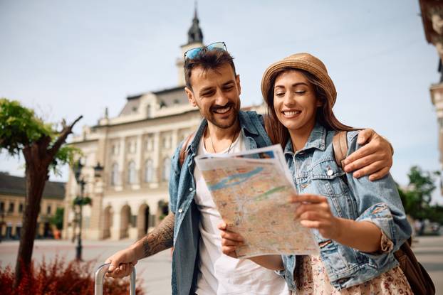 Happy,Couple,Enjoying,In,Travel,While,Exploring,A,Map,During