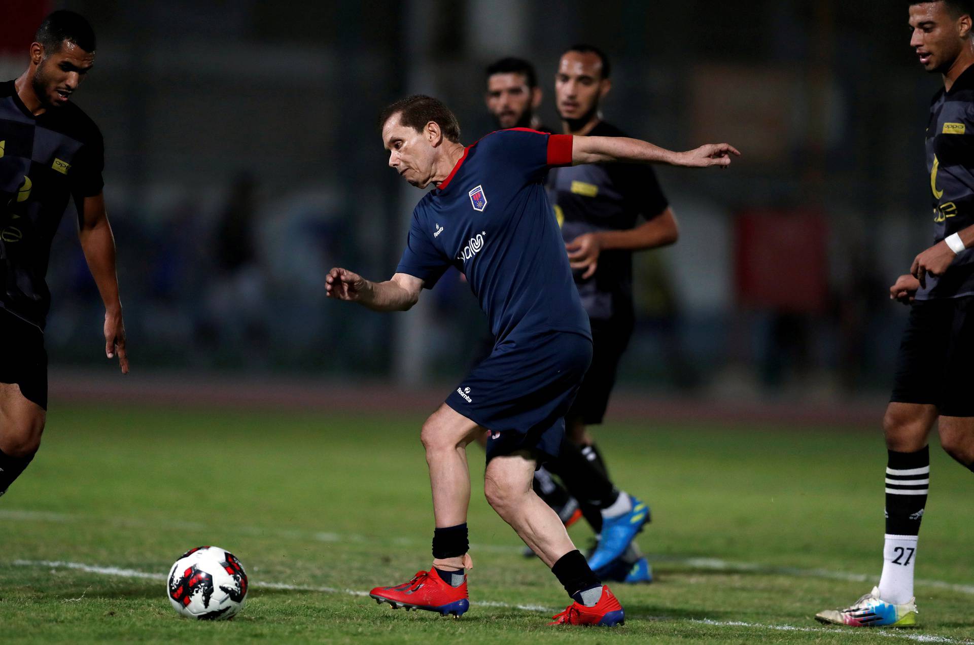 Ezzeldin Bahader, a 74-years-old Egyptian football player of 6th October Club is seen in action during a soccer match against El Ayat Sports Club of Egypt's third division league at the Olympic Stadium in the Cairo suburb of Maadi