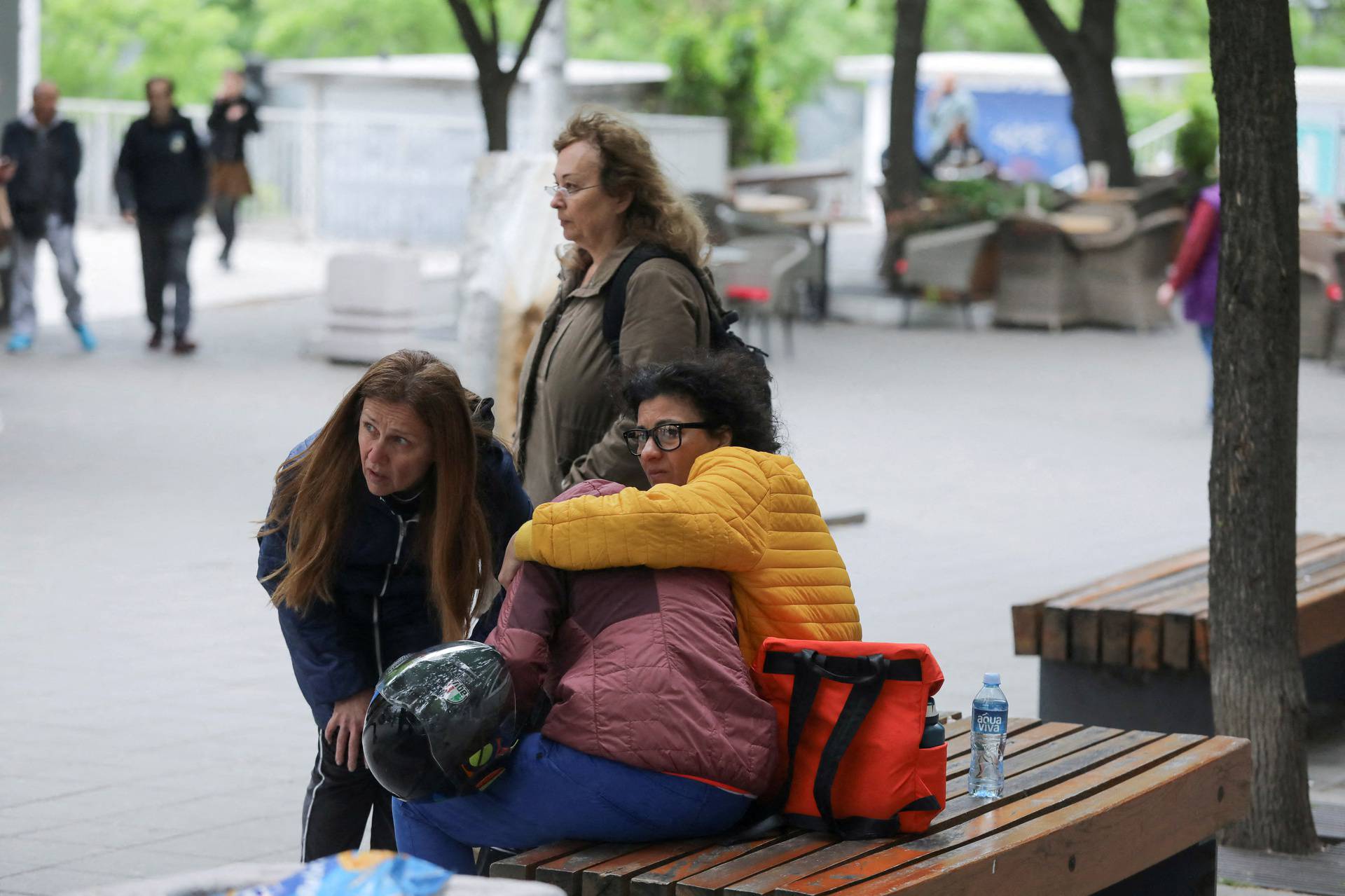 People react after a 14-year-old boy opened fire on other students and security guards at a school in downtown Belgrade