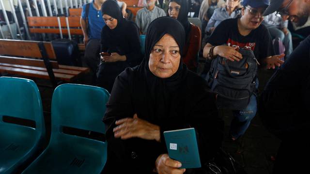 Palestinians with dual citizenship wait for permission to leave Gaza, at the Rafah border crossing with Egypt