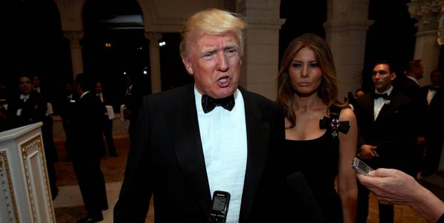 U.S. President-elect Donald Trump talks to reporters as he and his wife Melania Trump arrive for a New Year