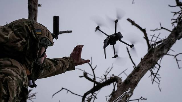 Ukrainian serviceman launches a kamikaze FPV drone at a front line near the city of Bakhmut