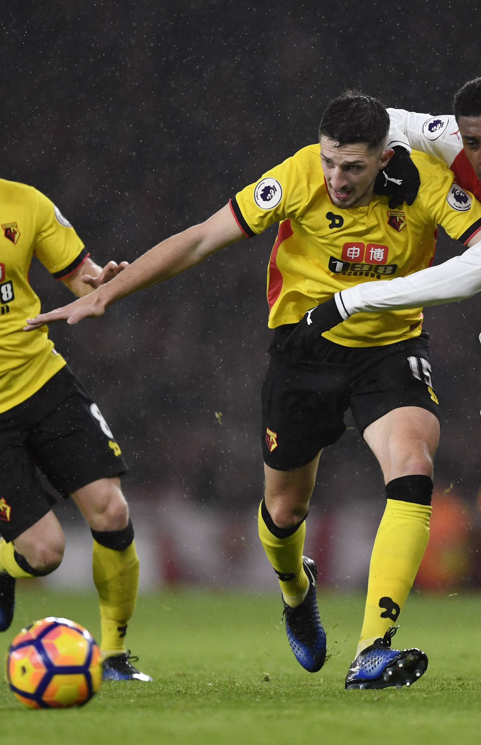 Arsenal's Alex Iwobi in action with Watford's Craig Cathcart and Tom Cleverley