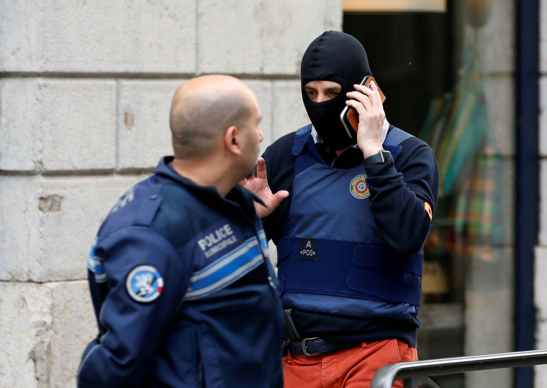 Police officers are seen near the site of a suspected bomb attack in central Lyon