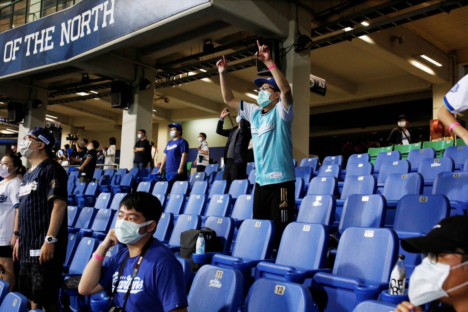 Baseball fans react to their team while wearing face masks at the first professional league game that allow audience since the outbreak of the coronavirus disease (COVID-19) in Taipei