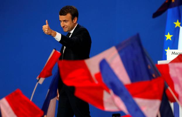 Emmanuel Macron, head of the political movement En Marche !, or Onwards !, and candidate for the 2017 French presidential election, gestures to supporters after the first round of 2017 French presidential election in Paris