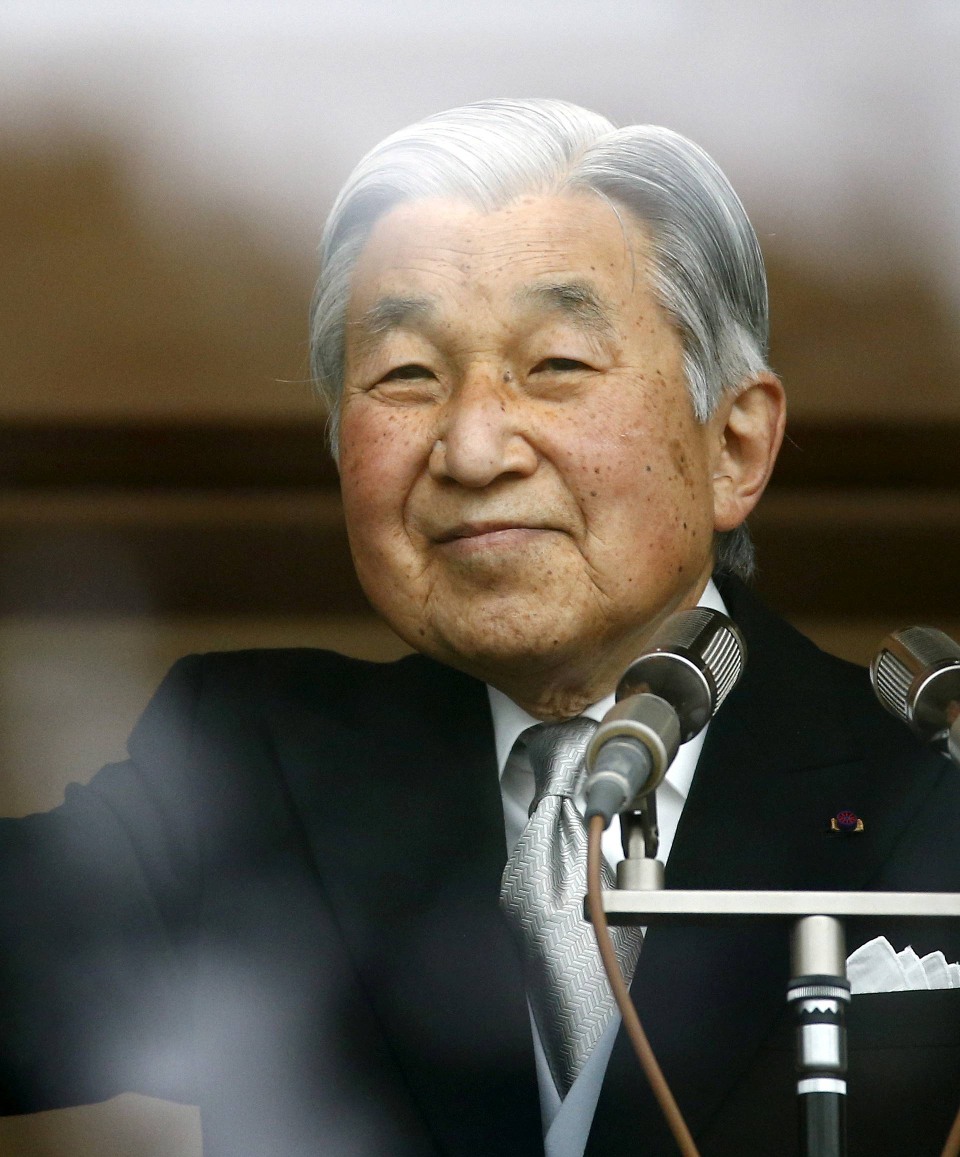 Japan's Emperor Akihito's waves to well-wishers at the Imperial Palace in Tokyo