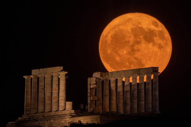 Full moon rises behind the Temple of Poseidon in Cape Sounion