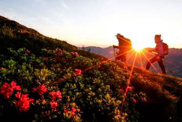 A couple hikes during sunrise on Kreuzjoch mountain in the Zillertal Alps in Schwendau