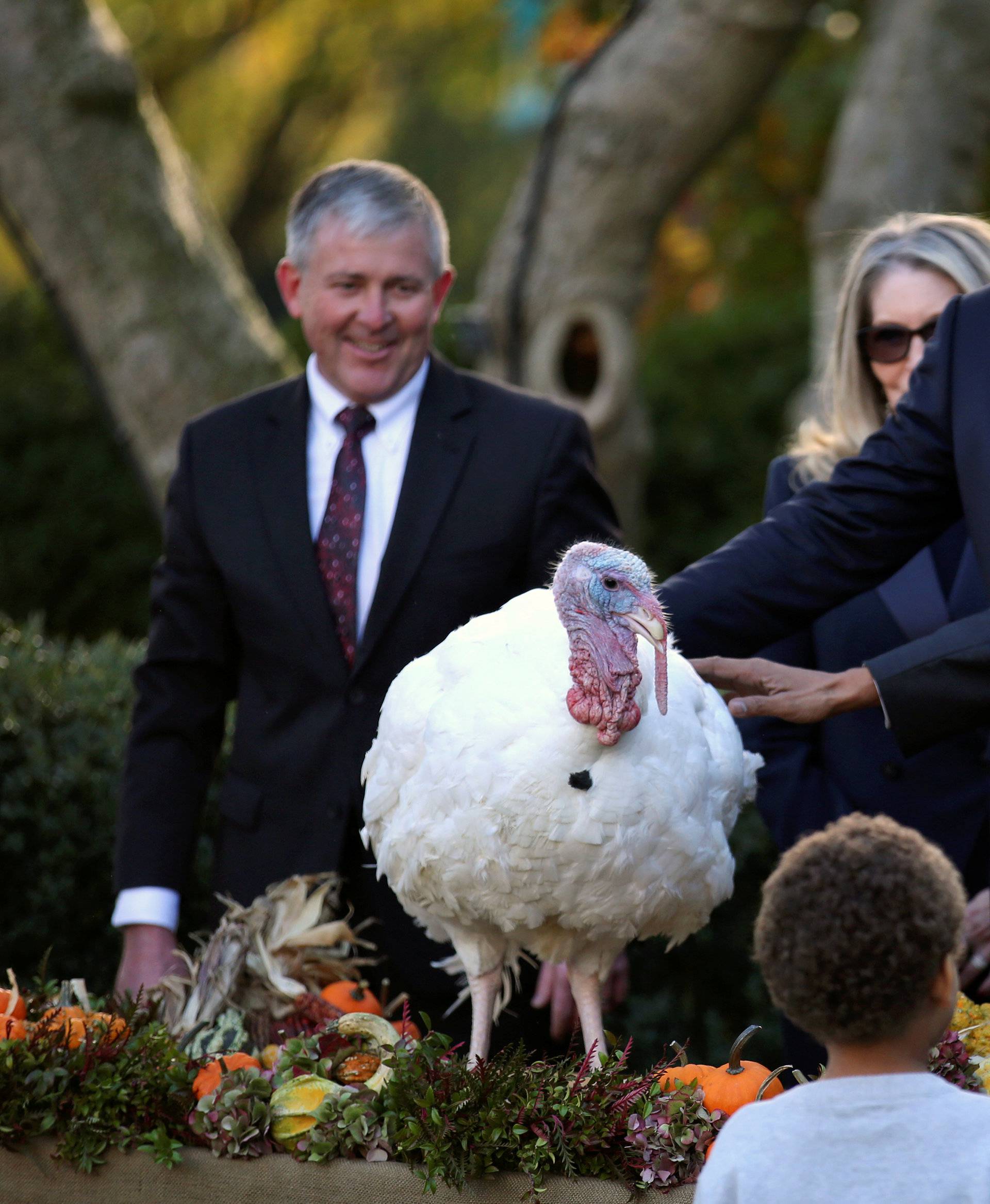 U.S. President Barack Obama attends the pardoning of National Thanksgiving turkey accompanied his nephews Aaron Robinson and Austin Robinson at the Rose Garden of the White House in Washington
