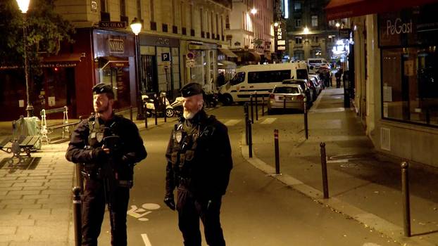 Police guard the scene of a knife attack in Paris