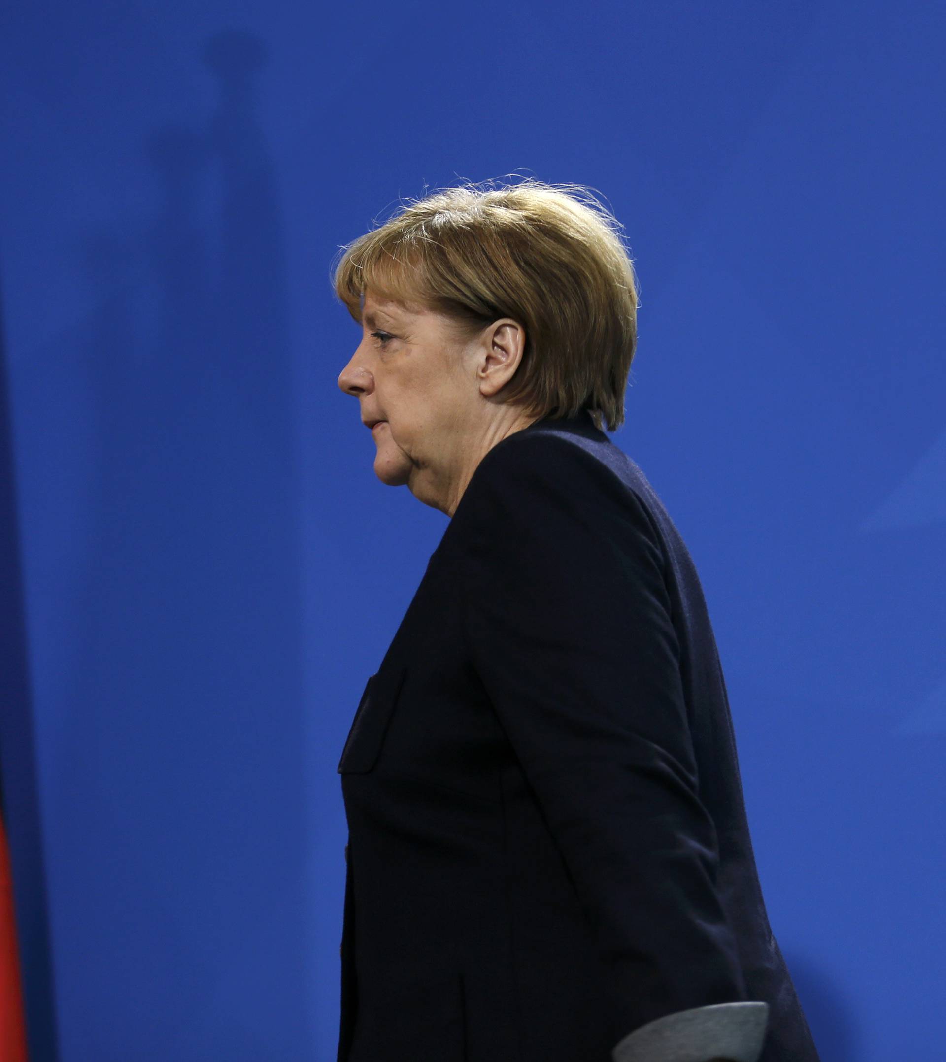 German Chancellor Angela Merkel leaves a news conference in Berlin