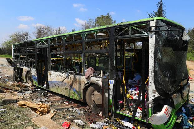 A damaged bus is seen after an explosion yesterday at insurgent-held al-Rashideen