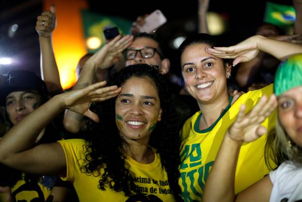 Supporters of Jair Bolsonaro react after Bolsonaro won the presidential race, in Brasilia